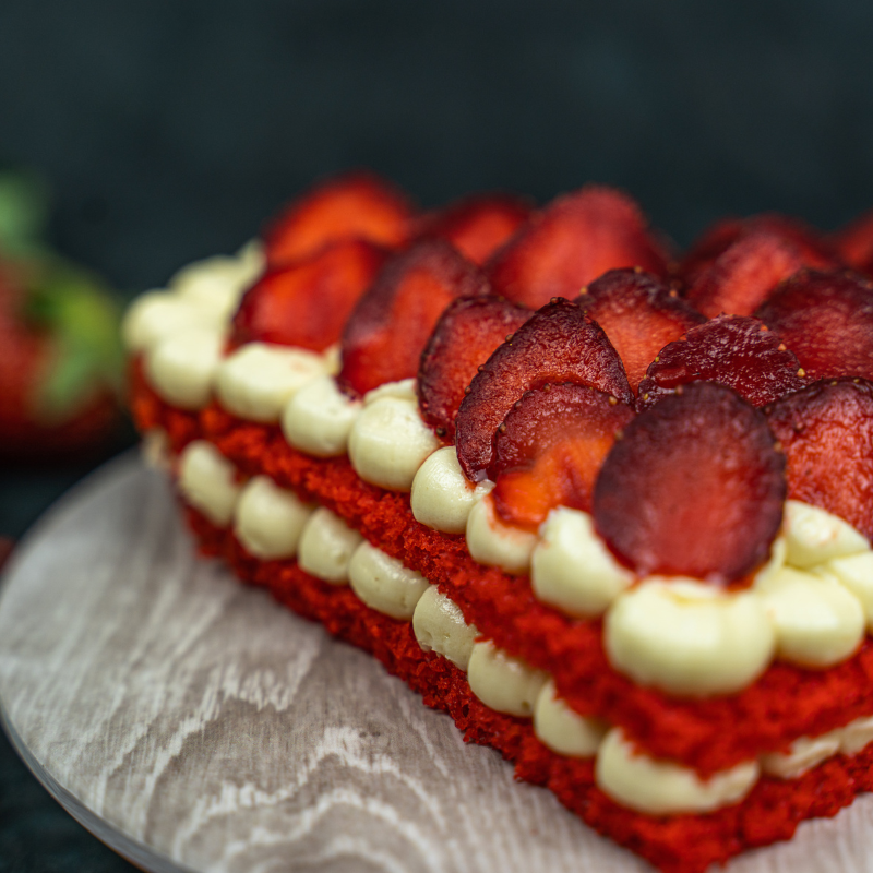 strawberry pinata cake loaded with fresh strawberry between layers of red velvet and luscious cream cheese frosting available for home delivery in bangalore