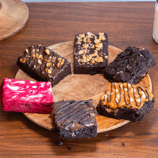 top shot of a  mixed pack of our best brownie flavors - red velvet swirl, fudgy walnut, peanut butter crunch, Nutella hazelnut, caramel sea salt, and Oreo!